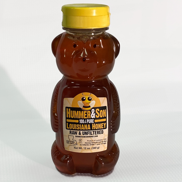 A bottle of Honey Bear with a teddy bear on it.