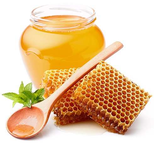 Honey and a spoon on a white background.